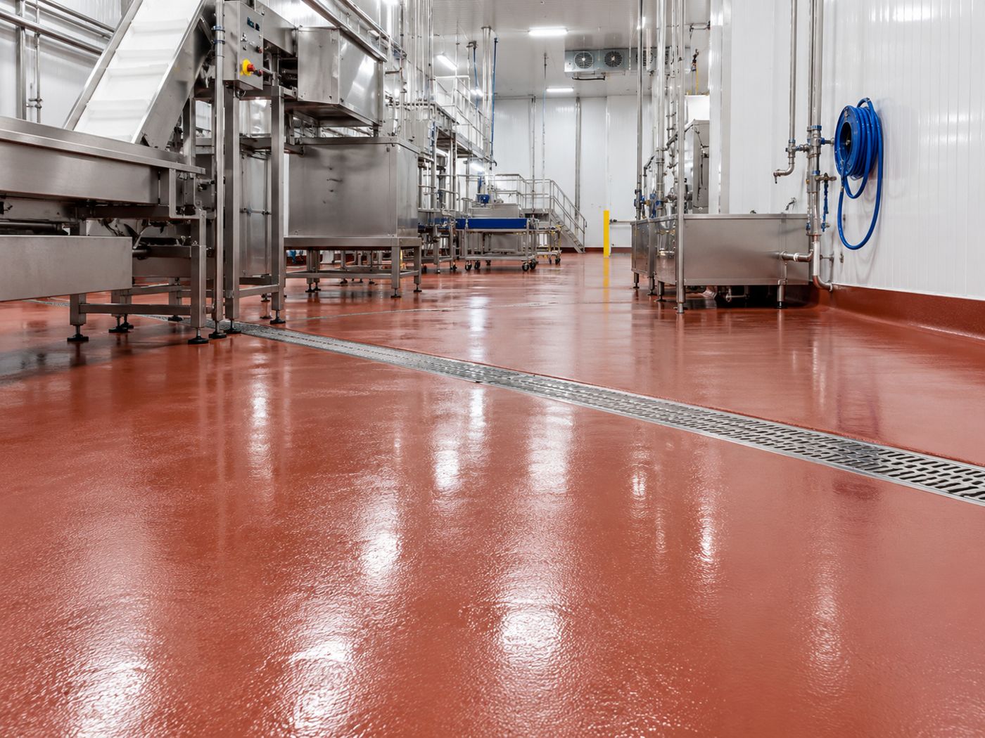 Seamless red urethane cement floor in a food processing plant